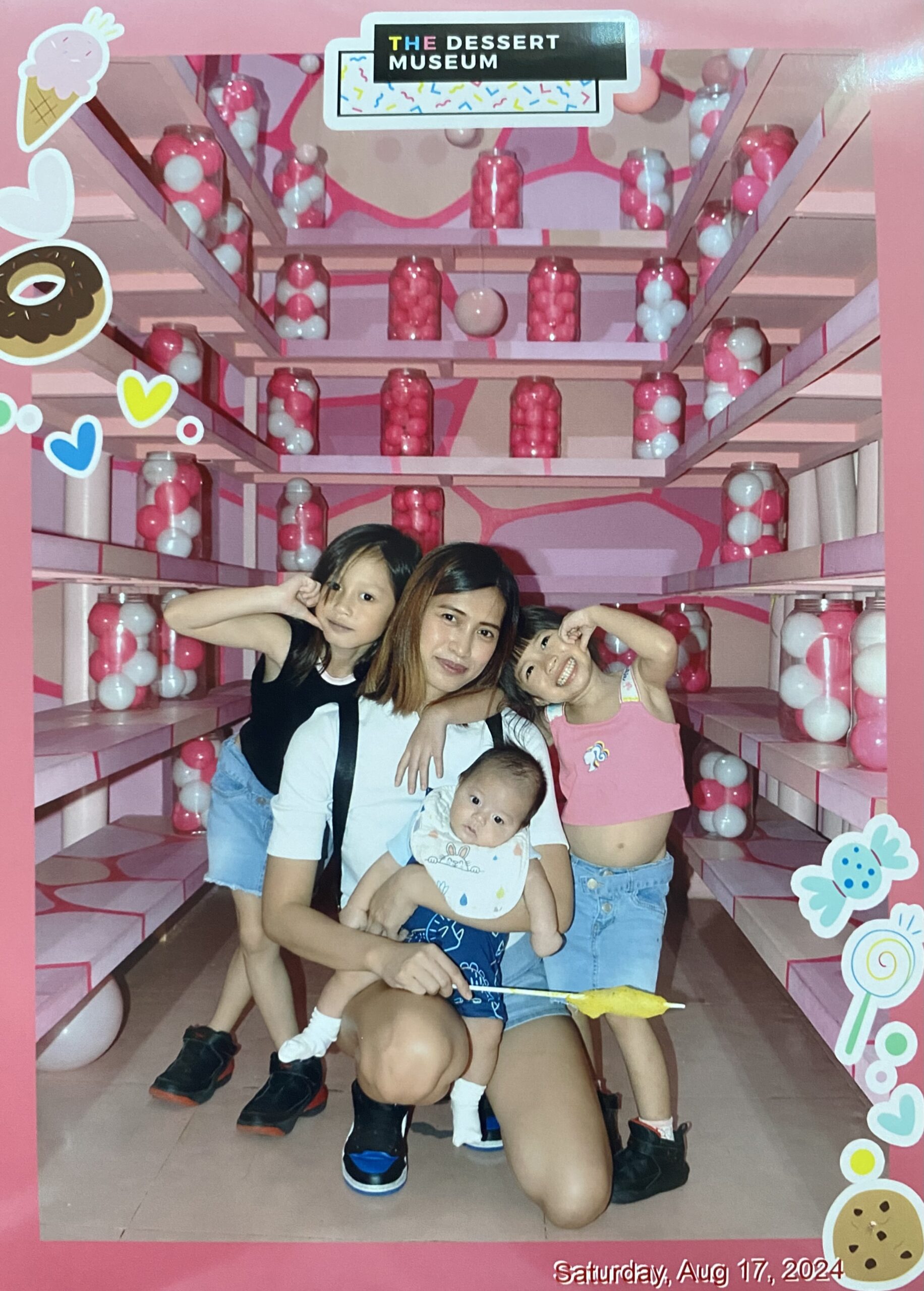 Ces with her three kids posing at the Dessert Museum in Manila.