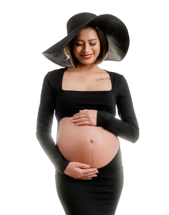 Smiling pregnant woman holding her belly – Crumbs and Calendars hero image