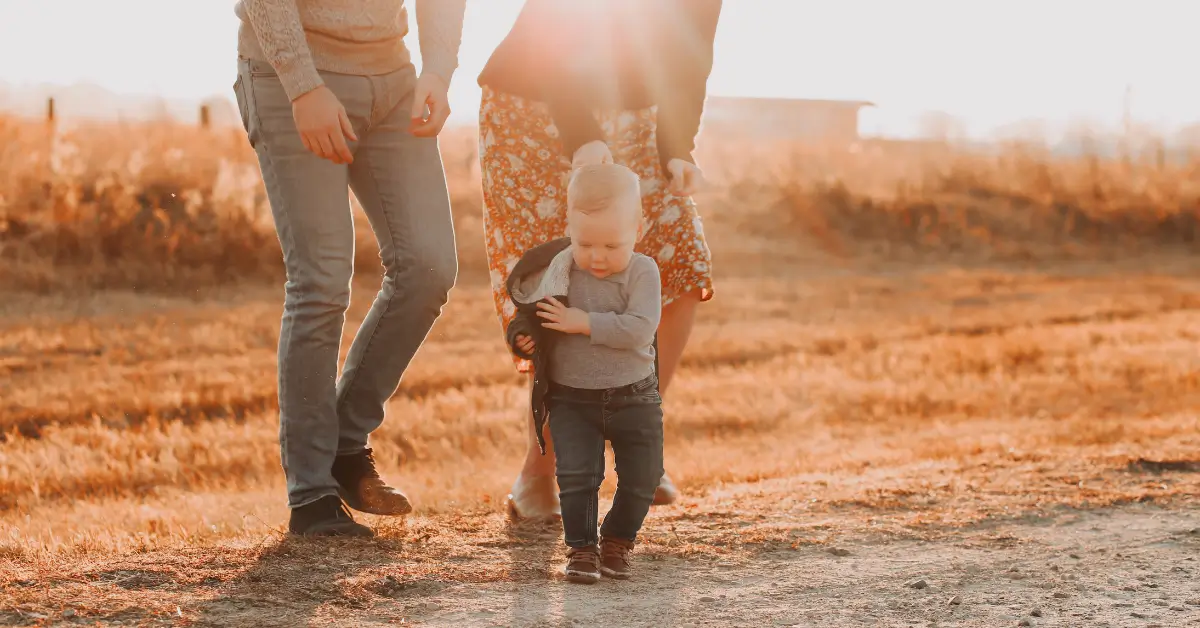 What is coparenting concept with parents walking with child outdoors.